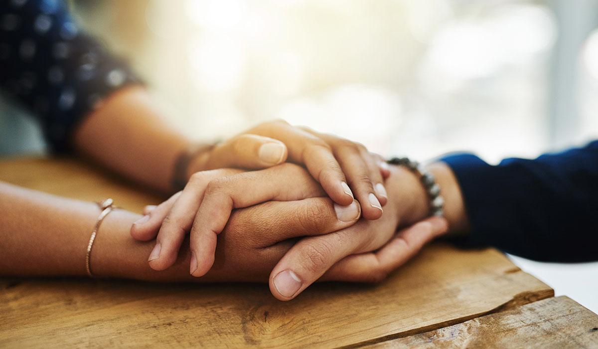 Closeup shot of two unrecognizable people holding hands in comfort